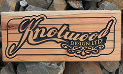 knotwood desgin ltd carved into macrocarpa wooden sign wtih black painted text 