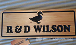 wooden house sign carved made out of macrocarpa