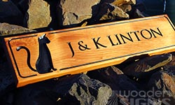 macrocarpa sign carved wiith cat image and V grooved font
