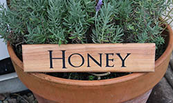 honey sign macrocarpa 300mm x 65mm ontop lavander plant link to small signs