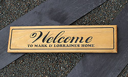 Welcome sign H3 pine carved with black text 